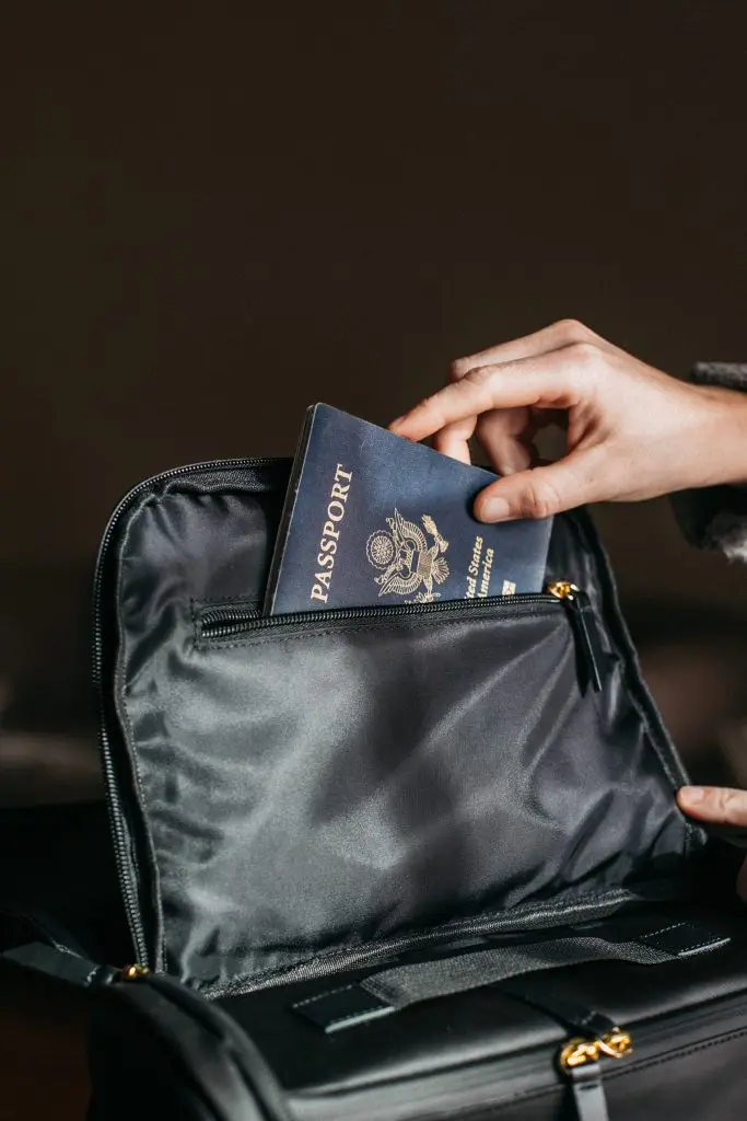 person putting a passport on bag 842961 scaled
