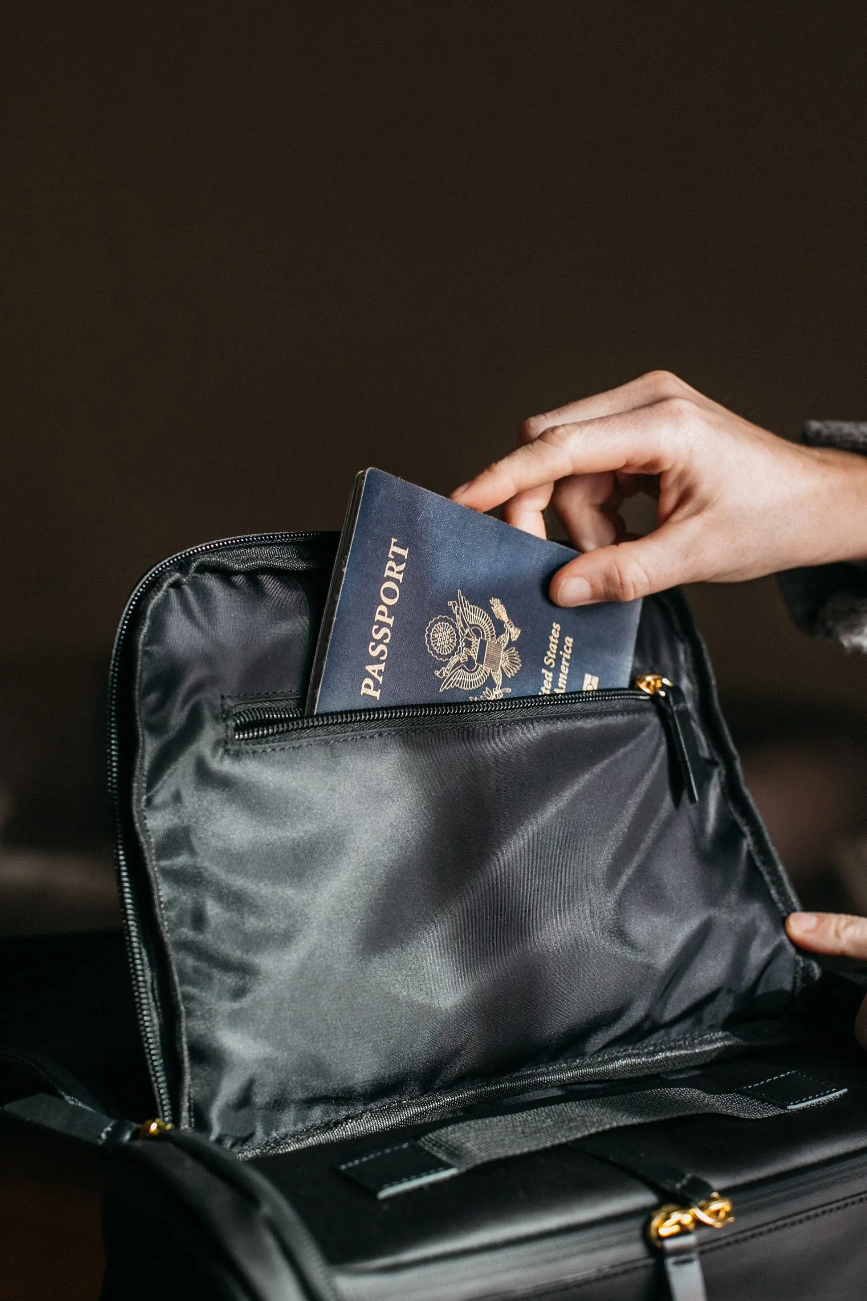 person putting a passport on bag 842961 scaled