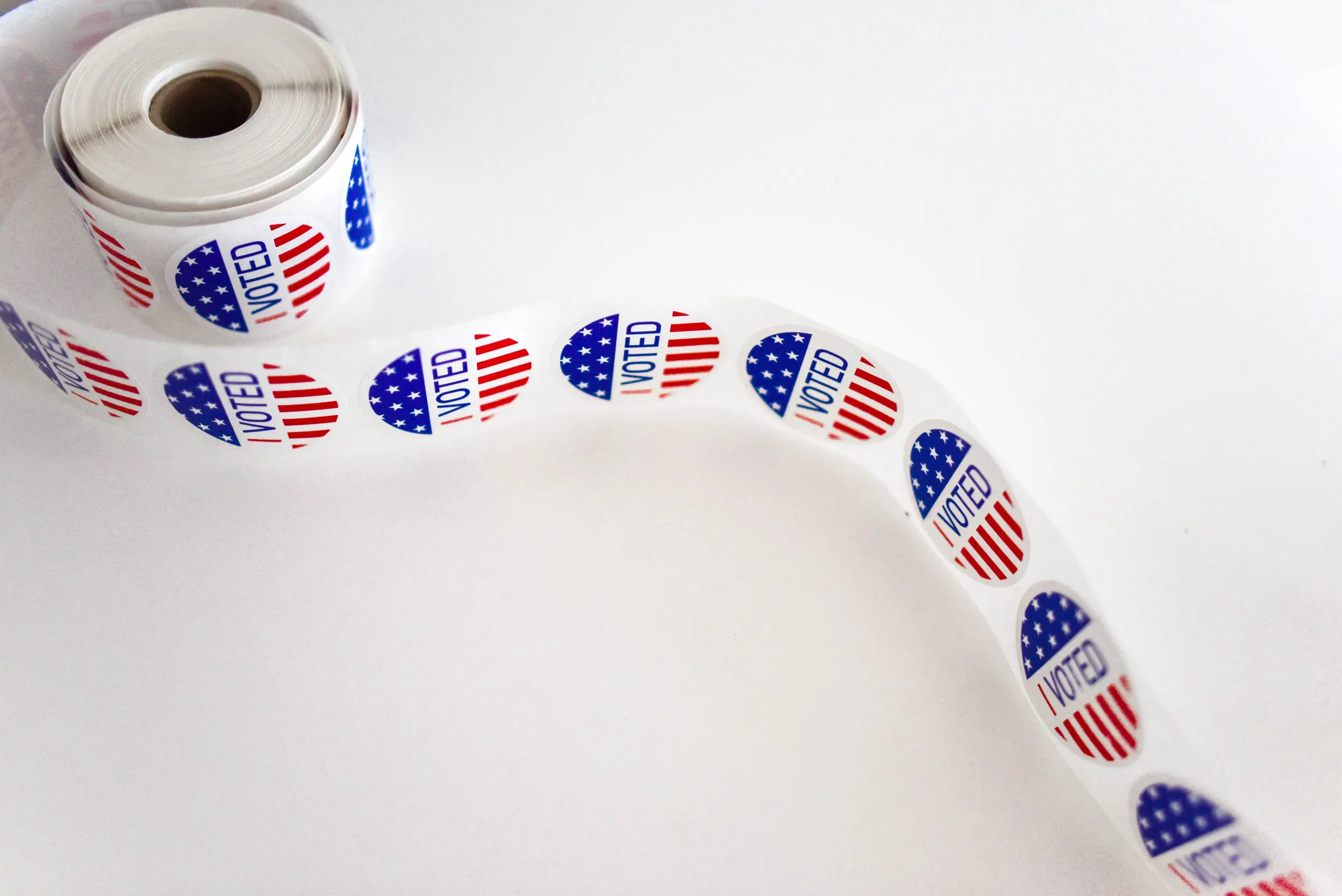 i voted sticker spool on white surface 1550336 scaled