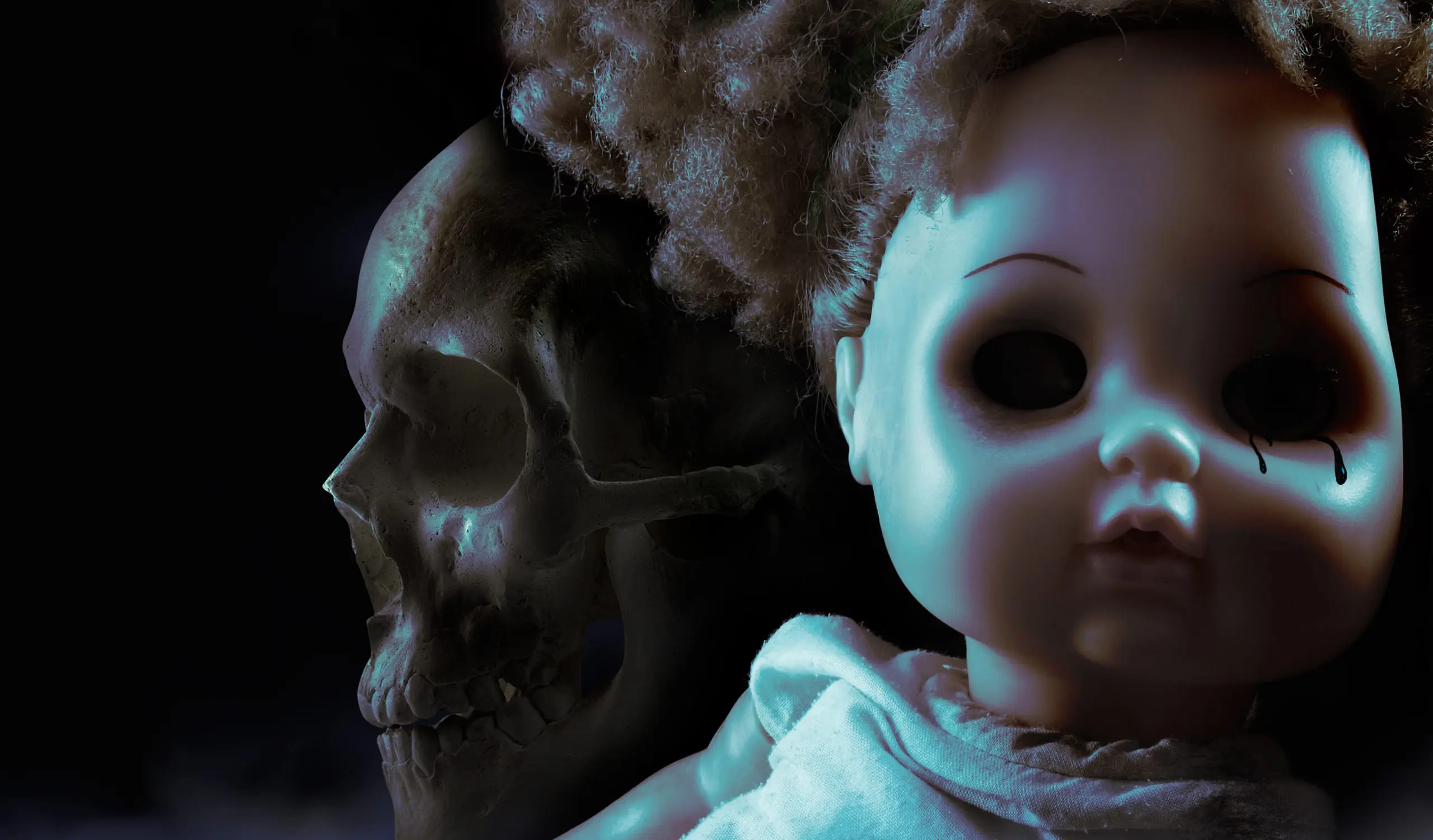 Scary horror plastic doll face with black tears and human skull