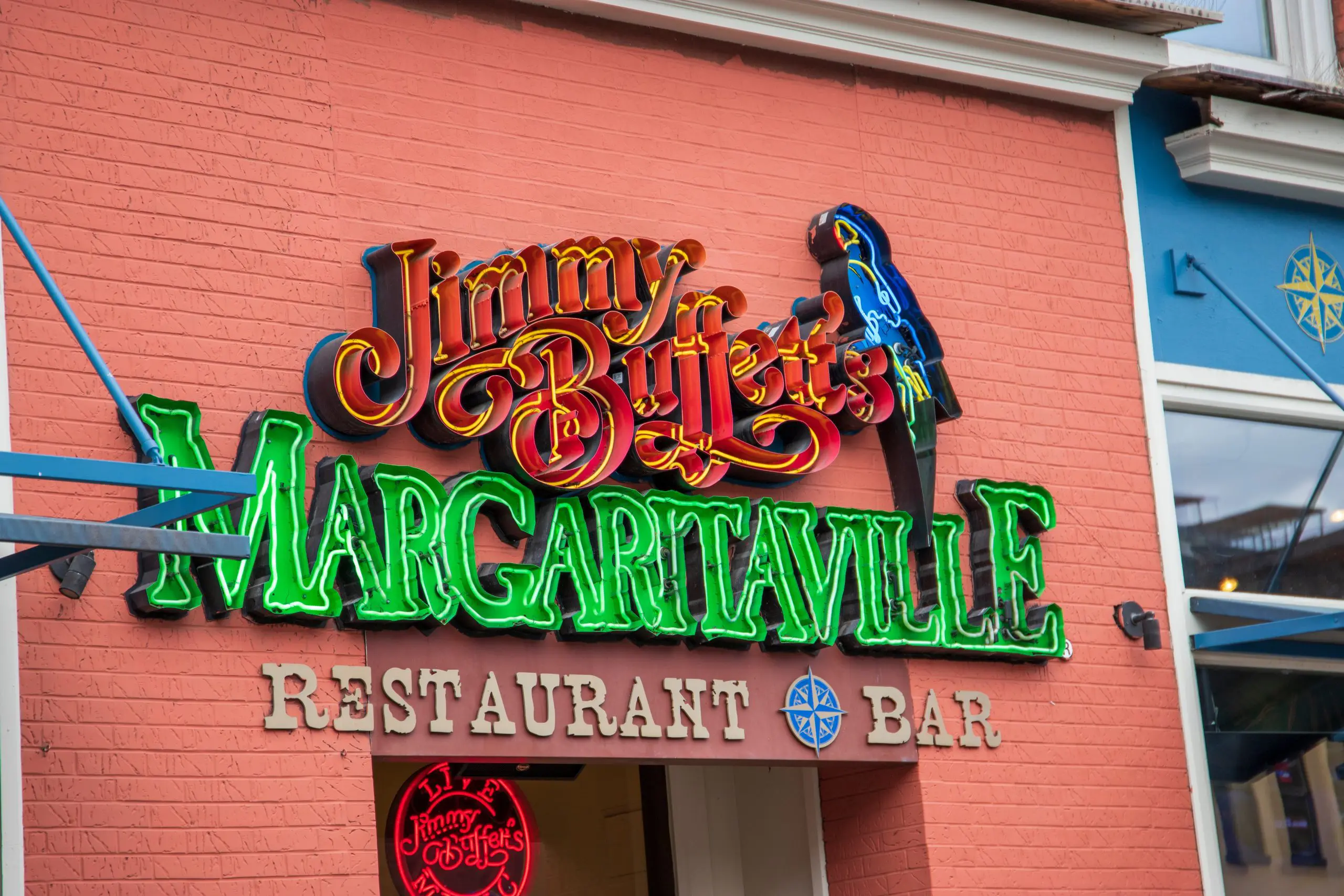 A shot of the neon sign outside of Jimmy Buffett’s Margaritaville restaurant and bar along Broadway street on a cloudy day in Nashville Tennessee USA