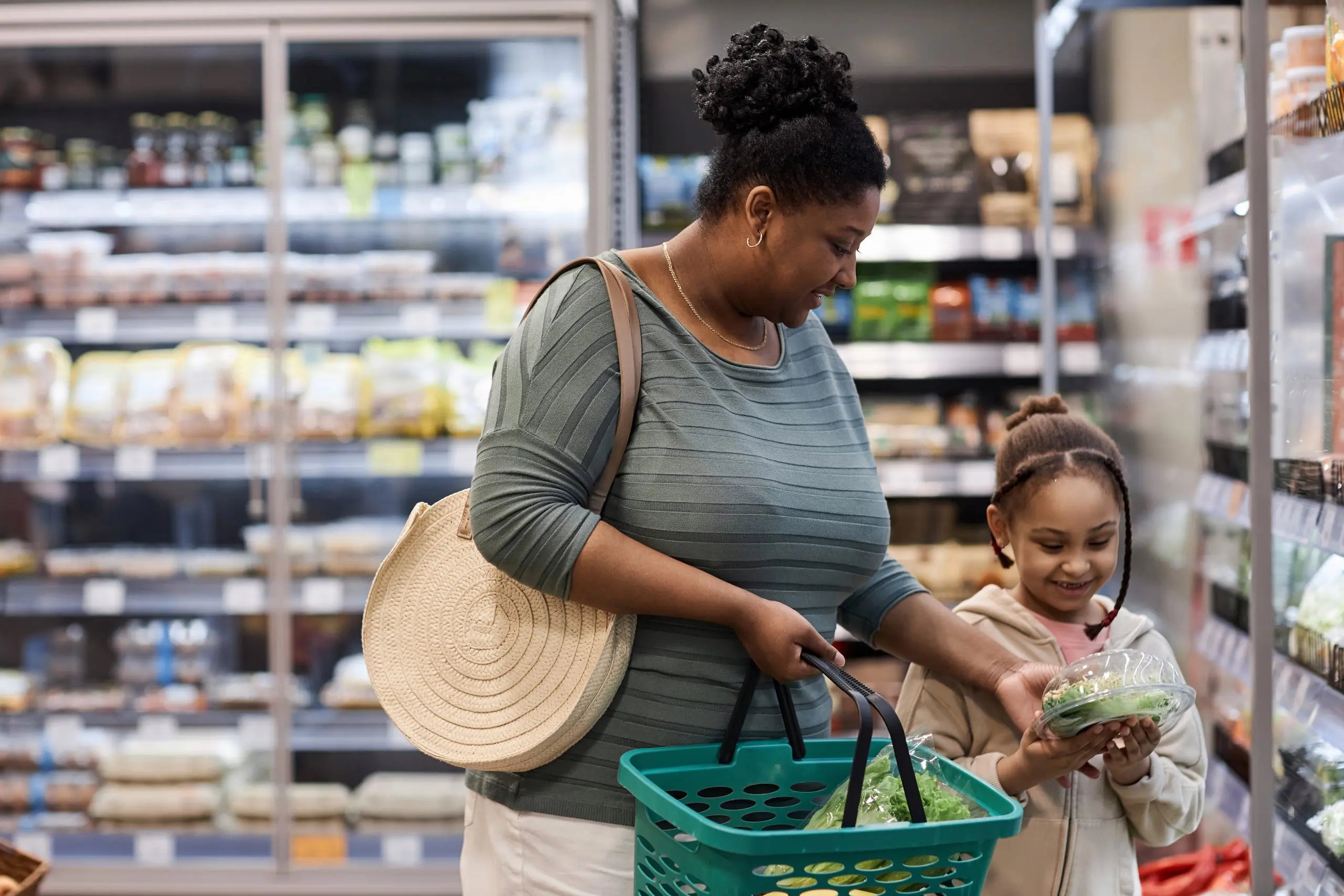 Mother shopping in supermarket with little daughter Mother shopping in supermarket with little daughter