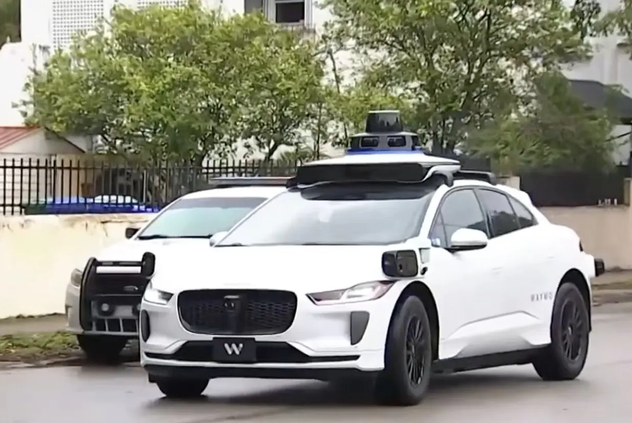 Waymo stop in Miami traffic near police cruiser