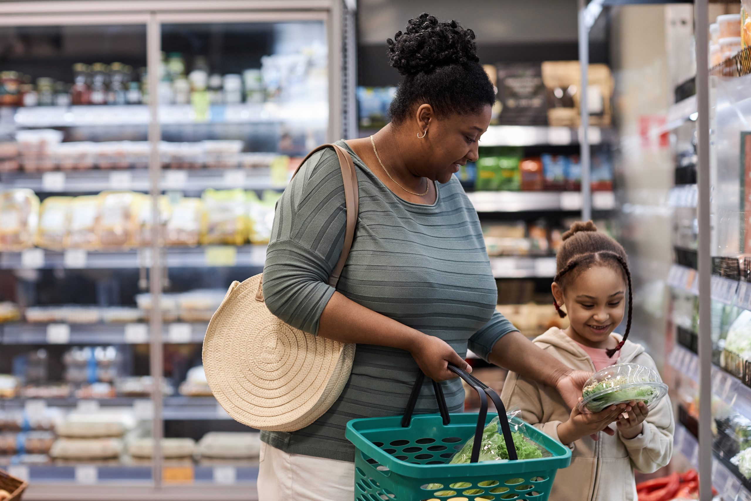 Mother shopping in supermarket with little daughter Mother shopping in supermarket with little daughter